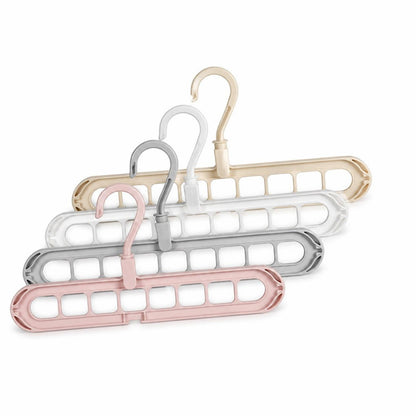 Space-saving multi-hole clothes hangers in pink, gray, white and beige