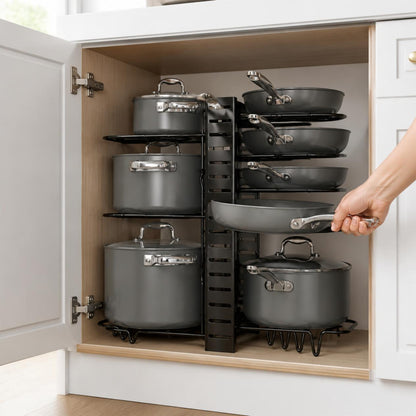 Pulling a pan from the pot rack inside a kitchen cabinet